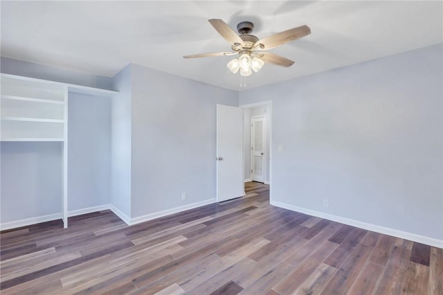 empty room featuring ceiling fan and dark wood-type flooring