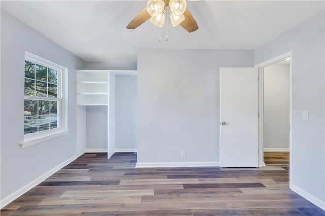 unfurnished room with dark hardwood / wood-style flooring and ceiling fan