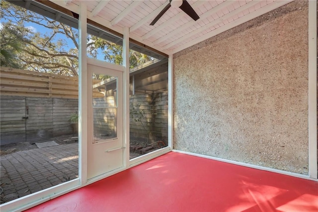 unfurnished sunroom with ceiling fan