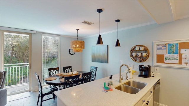 kitchen with visible vents, dishwasher, light countertops, hanging light fixtures, and a sink