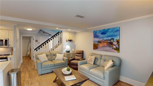 living room with visible vents, stairway, light wood-style floors, crown molding, and baseboards