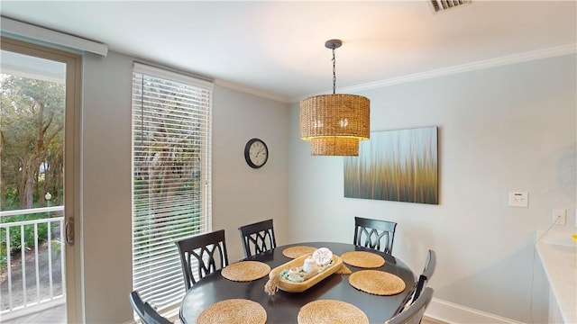 dining space with baseboards, visible vents, and ornamental molding