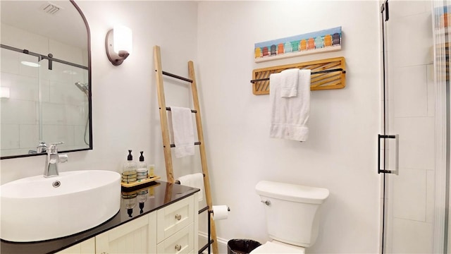 full bathroom featuring visible vents, a shower stall, toilet, and vanity