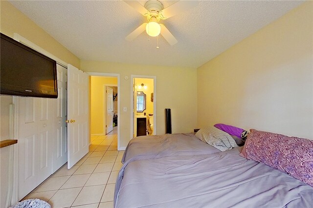 940 Azalea St, Blackshear, GA 31516 - bedroom featuring light tile patterned floors, ceiling fan, a textured ceiling, and connected bathroom