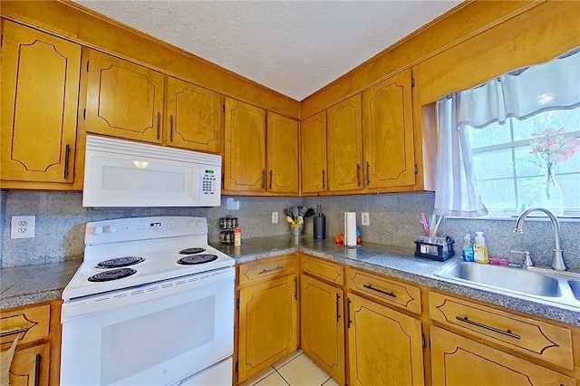 940 Azalea St, Blackshear, GA 31516 - kitchen with white appliances, a sink, backsplash, brown cabinets, and a textured ceiling