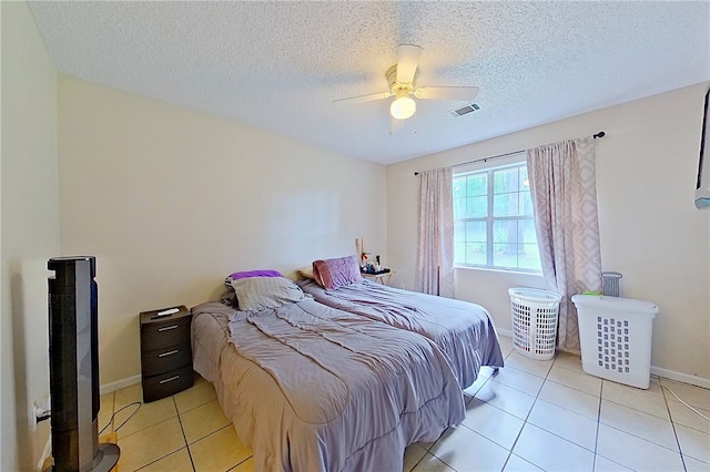 940 Azalea St, Blackshear, GA 31516 - bedroom featuring light tile patterned flooring, baseboards, ceiling fan, and a textured ceiling
