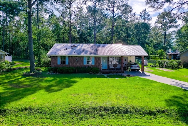 940 Azalea St, Blackshear, GA 31516 - ranch-style home featuring asphalt driveway, a front lawn, covered porch, brick siding, and metal roof