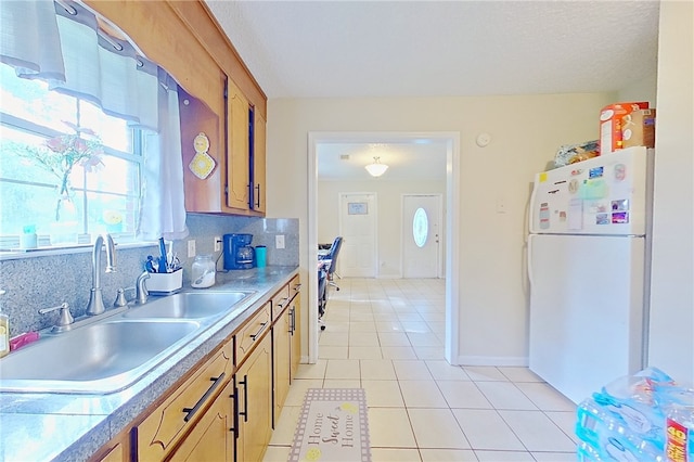 940 Azalea St, Blackshear, GA 31516 - kitchen with freestanding refrigerator, a sink, light tile patterned floors, light countertops, and baseboards