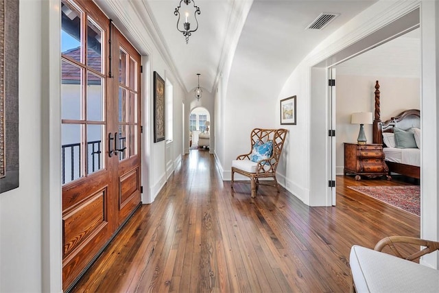 hall with ornamental molding, dark hardwood / wood-style flooring, and french doors