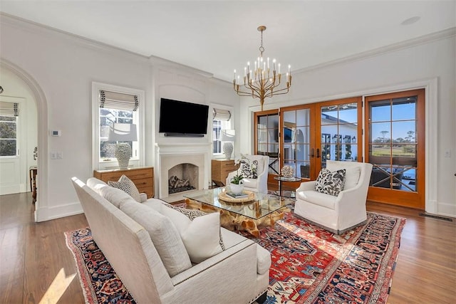 living room featuring plenty of natural light, a chandelier, and hardwood / wood-style floors