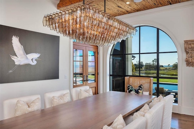 dining area featuring wood ceiling, a chandelier, wood-type flooring, a healthy amount of sunlight, and french doors