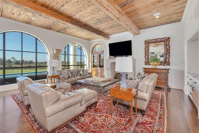 living room featuring beam ceiling, hardwood / wood-style floors, and wooden ceiling