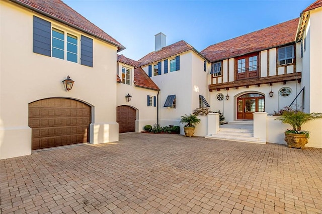 view of front facade featuring french doors and a garage