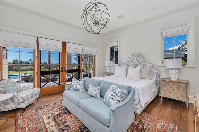 bedroom with multiple windows, access to exterior, a chandelier, and crown molding