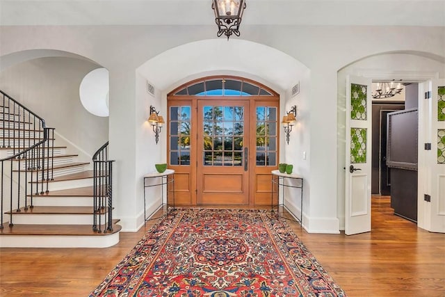 entrance foyer featuring an inviting chandelier and hardwood / wood-style flooring