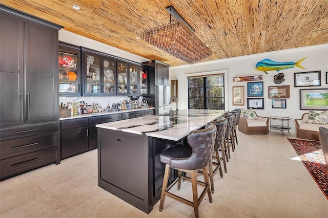 bar featuring wood ceiling, light stone countertops, pendant lighting, high quality fridge, and sink