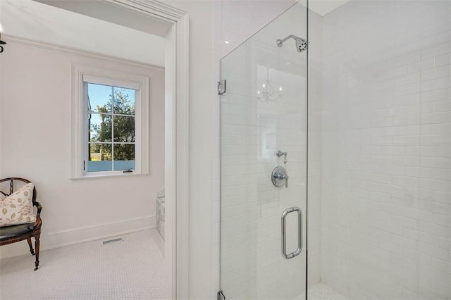 bathroom with tile patterned flooring and a shower with shower door