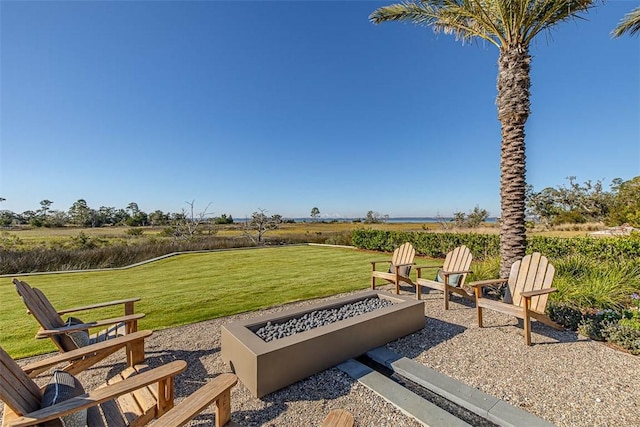 view of yard with a fire pit, a rural view, and a patio area