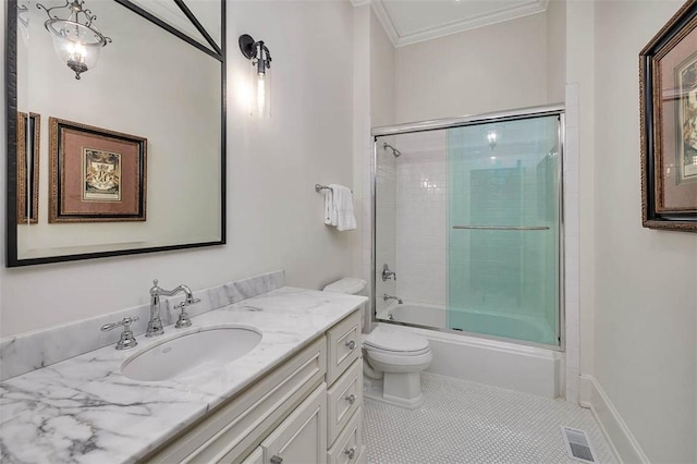 full bathroom with tile patterned flooring, shower / bath combination with glass door, toilet, vanity, and crown molding