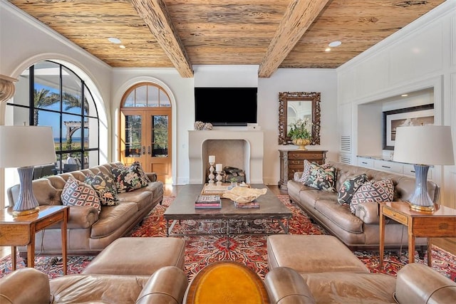 living room featuring beam ceiling, french doors, wooden ceiling, and crown molding