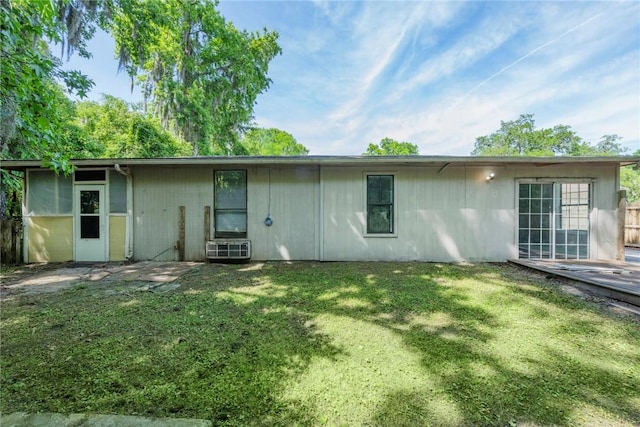 rear view of property featuring a yard
