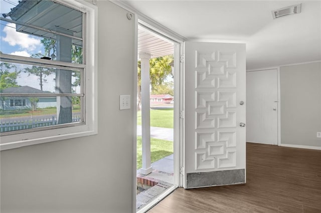 entryway with wood finished floors, plenty of natural light, and visible vents