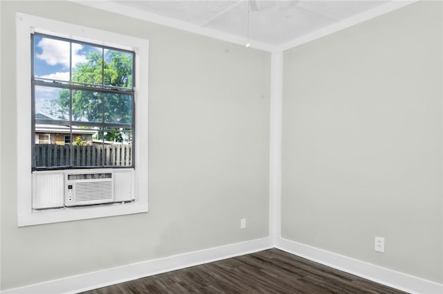 empty room with cooling unit, dark wood-style floors, and baseboards