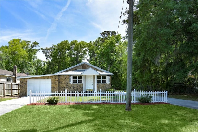 view of front of property featuring a front yard, driveway, stone siding, and a garage