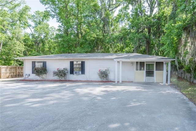 single story home featuring fence