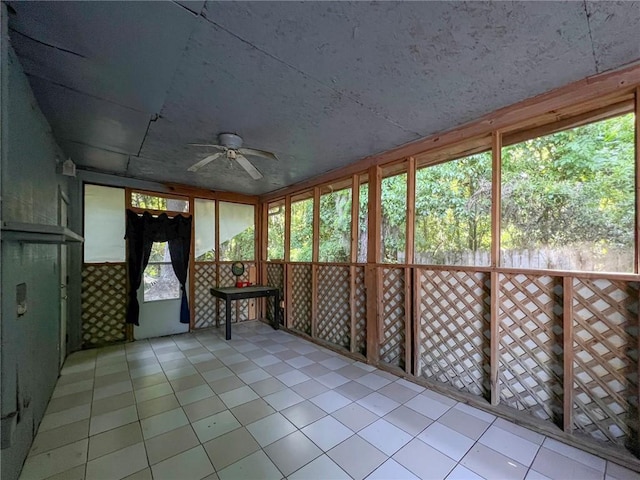 unfurnished sunroom featuring ceiling fan