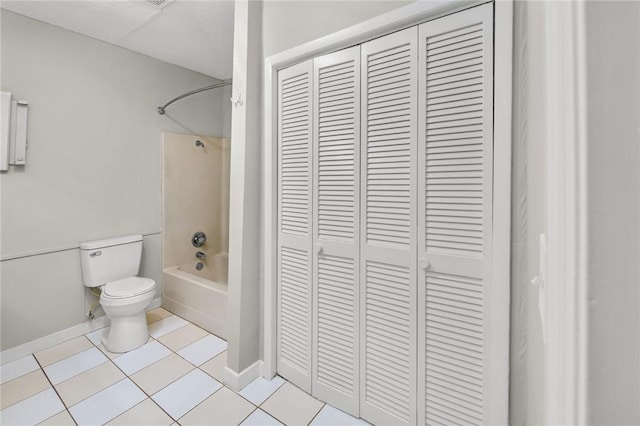 full bathroom with toilet, a closet, shower / washtub combination, and baseboards