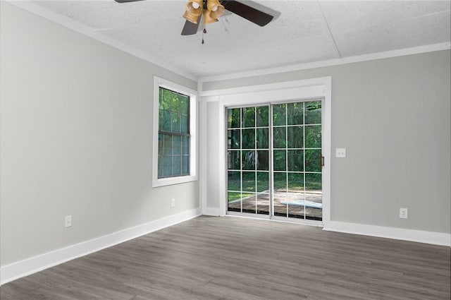 spare room with baseboards, wood finished floors, a ceiling fan, and a textured ceiling