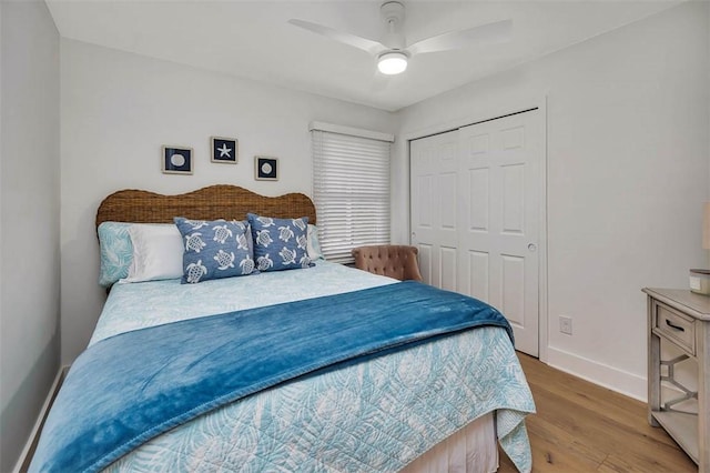 bedroom featuring hardwood / wood-style floors, ceiling fan, and a closet