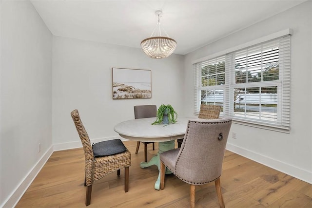 dining room with a notable chandelier and light hardwood / wood-style floors