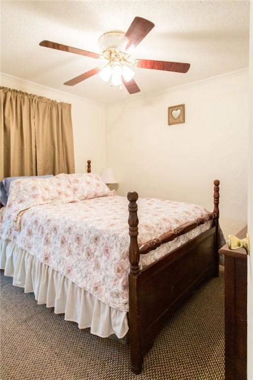 2896 S Lakeview Dr, Waycross, GA 31503 - bedroom featuring carpet, crown molding, and a ceiling fan