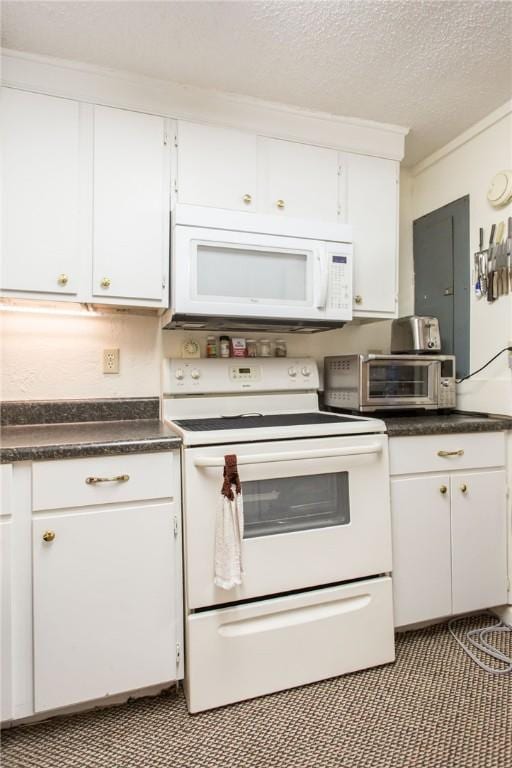 2896 S Lakeview Dr, Waycross, GA 31503 - kitchen with white appliances, white cabinetry, dark countertops, and a textured ceiling