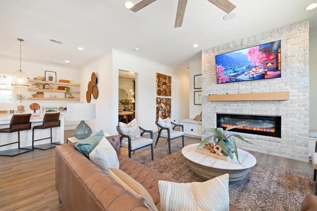 108 Fox Run Dr, Brunswick, GA 31525 - living room with visible vents, wood finished floors, a ceiling fan, and a fireplace