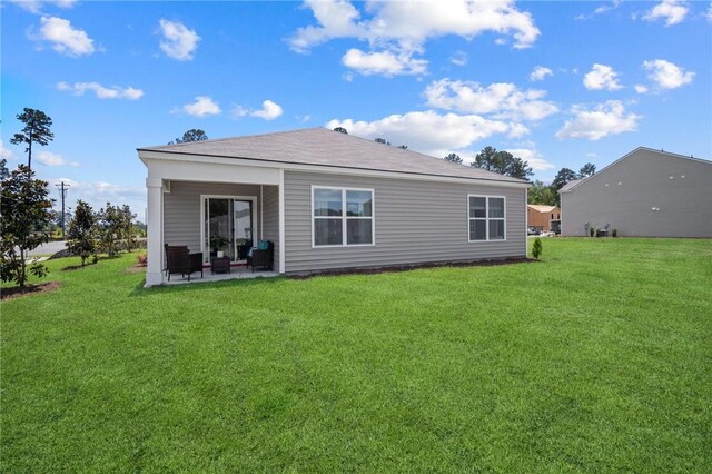 331 Elizabeth Dr, Brunswick, GA 31525 - rear view of property with a yard, a patio area, and an outdoor hangout area