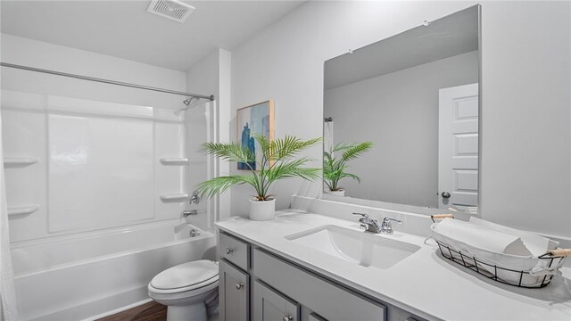 331 Elizabeth Dr, Brunswick, GA 31525 - bathroom with toilet, vanity, washtub / shower combination, and wood finished floors