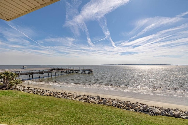 view of dock featuring a water view and a view of the beach