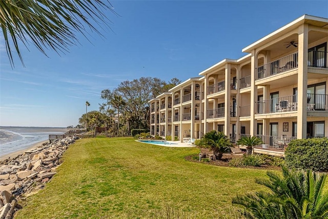 surrounding community featuring a lawn and a swimming pool