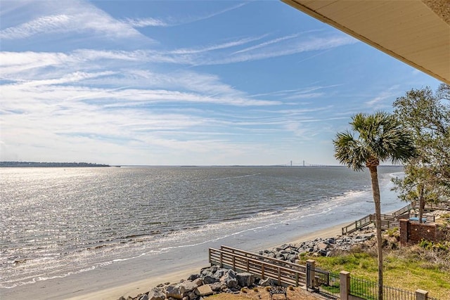 view of water feature with fence and a view of the beach