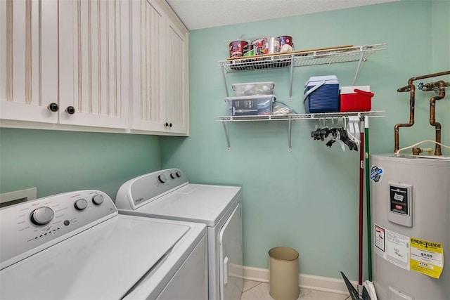 laundry room featuring light tile patterned floors, cabinet space, water heater, independent washer and dryer, and baseboards