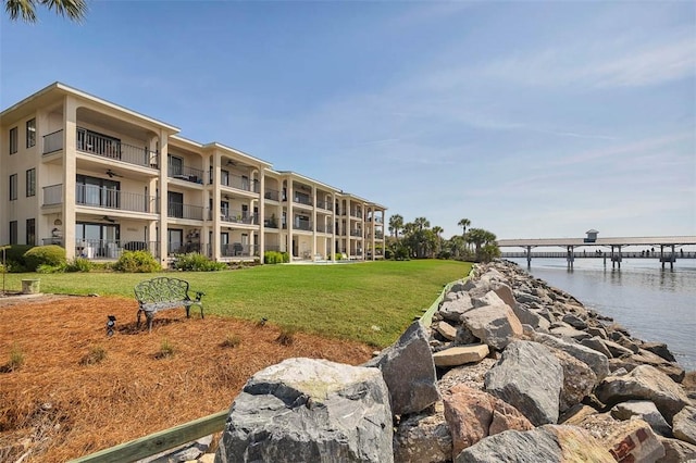 view of property's community featuring a yard and a water view