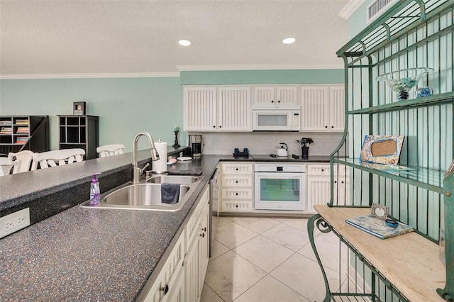 kitchen featuring white appliances, a sink, and crown molding