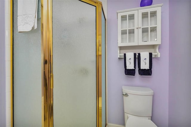 full bath featuring toilet and a shower stall