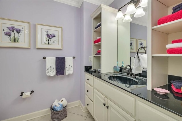 bathroom featuring ornamental molding, vanity, baseboards, and tile patterned floors