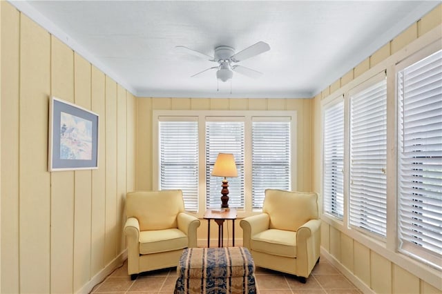 living area featuring ceiling fan and light tile patterned floors