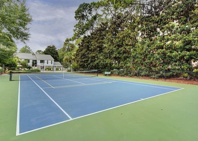 view of tennis court with basketball hoop