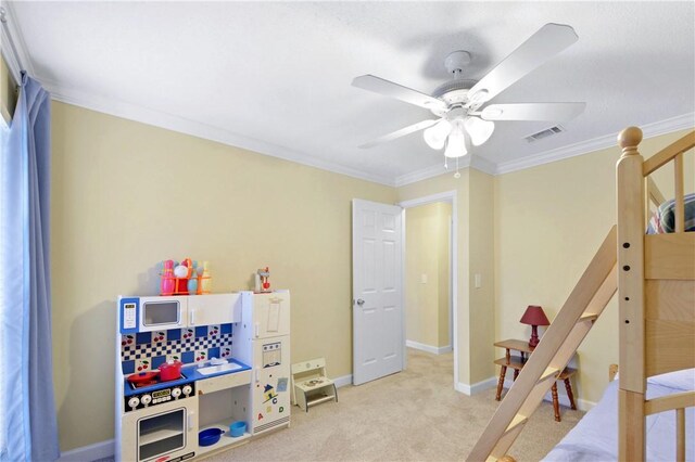 carpeted bedroom featuring ceiling fan and crown molding